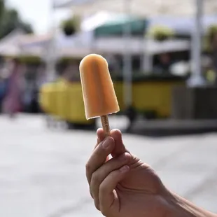 a person holding a popsicle