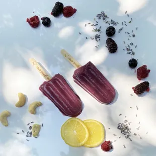 two popsicles with fruit on them