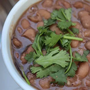 a bowl of beans and cilantro
