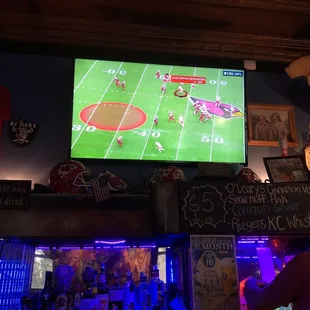 a man watching a football game on tv