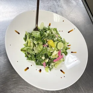 a salad in a bowl with a spoon