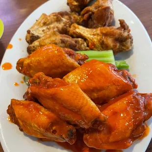 a plate of chicken wings and celery