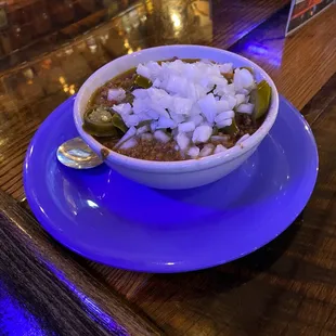 a bowl of chili and onions