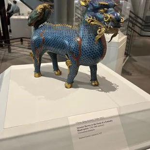 a blue dragon figurine on display