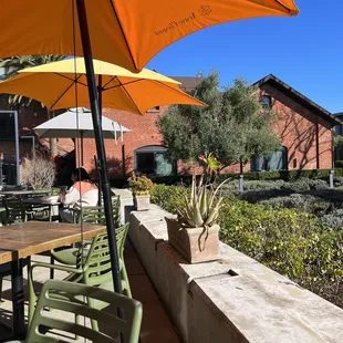 a patio with tables and umbrellas