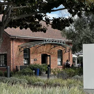a sign in front of a brick building