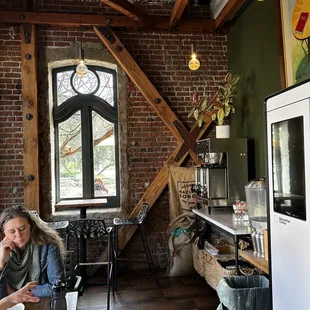 a woman sitting at a table in a kitchen