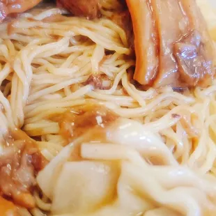 a plate of noodles with meat and sauce