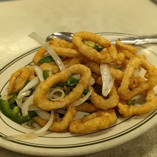 a plate of onion rings with a fork
