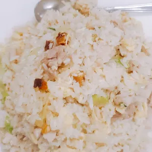 a plate of rice with meat and vegetables