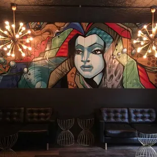 a mural of a woman with a colorful face