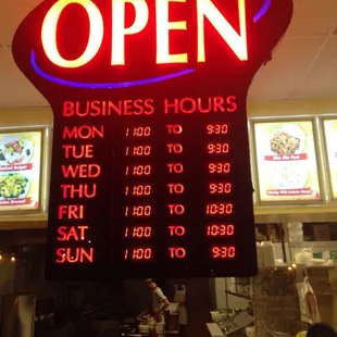 a neon sign for a business hours and hours
