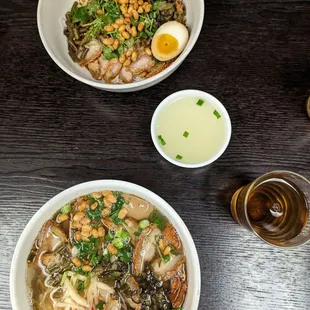 two bowls of soup and a glass of beer