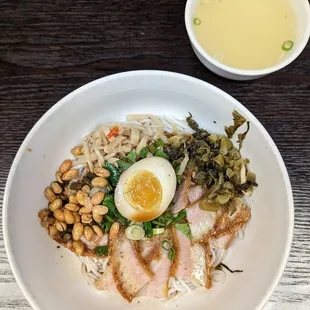 a plate of food with rice, meat, and vegetables