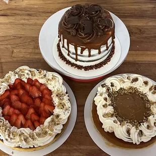 three cakes on plates