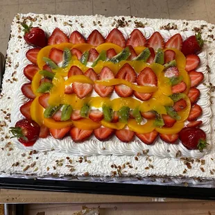 a cake with strawberries and kiwi