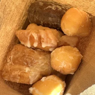 a brown paper bag filled with doughnuts