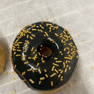 a chocolate frosted donut with sprinkles