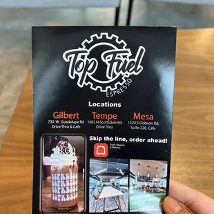 a hand holding a menu