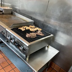 donuts cooking on a griddle in a commercial kitchen