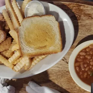 Fried catfish with fries, bbq baked beans and Texas toast