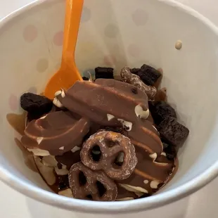 Peanut butter yogurt with hard shell chocolate sauce, brownie bits and chocolate covered pretzels