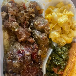 Oxtails, baked macaroni and cheese with greens and cornbread