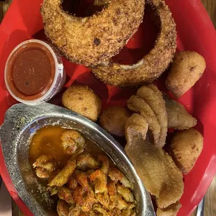 Fried catfish and crawfish combo with onion rings and hush puppies