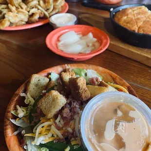  plate of salad and a bowl of dressing