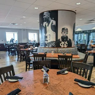 Inside. Dining room. Old black and white photos of Michael Jordan and an old UNC athlete decorate a column.