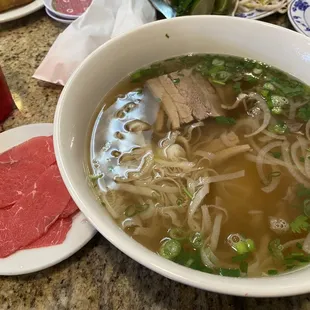 Pho with rare steak, tendon, tripe