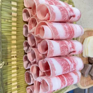 a basket of ham wrapped in bacon