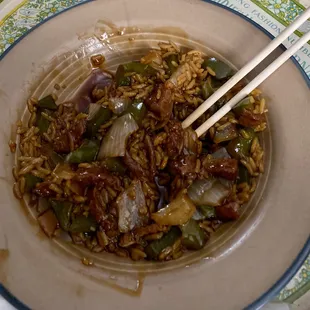 a bowl of rice with chopsticks