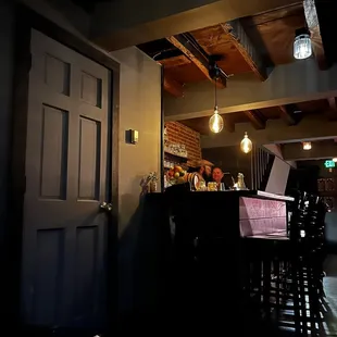 a bar with stools and lights