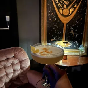 a person holding a cocktail glass