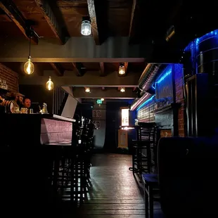 a dimly lit bar with stools