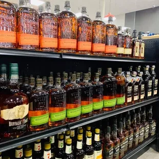bottles of liquor on shelves in a store