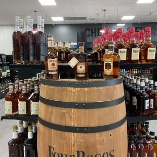 a display of bourbon bottles and barrels