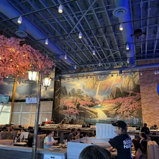 The impressive mural and tree and the lively atmosphere