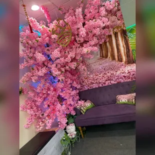 a purple couch with pink flowers