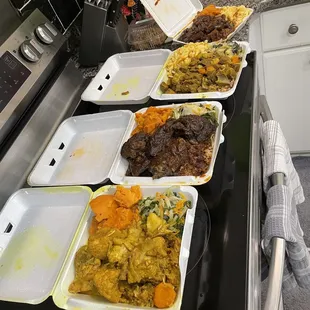 a row of take out containers filled with food