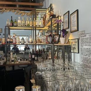 a bar filled with wine glasses