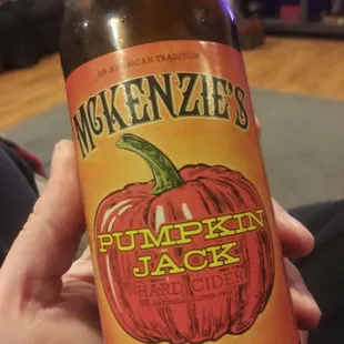 a person holding a bottle of pumpkin jack