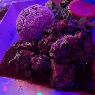 Oxtail, rice and peas, salad and fried plantains.