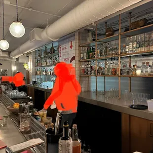 a bar with people sitting at the bar