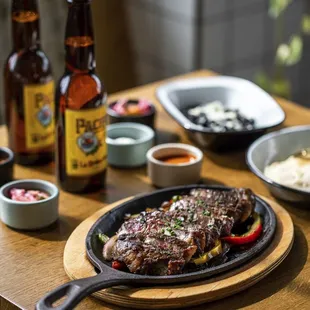 a steak on a plate with a side of beer