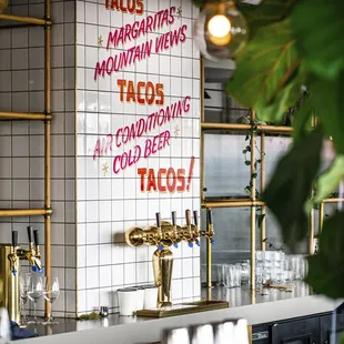 a bar with a menu on the wall