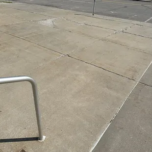 The sidewalk in front of the venue is cracked and apparently a rail was replaced and the old metal was left underneath the new.