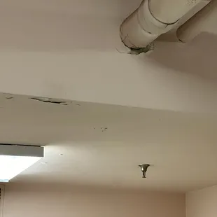 This is the ceiling downstairs. Apparently water has leaked. The paint is flashing off.