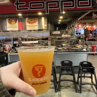 a person holding a glass of beer